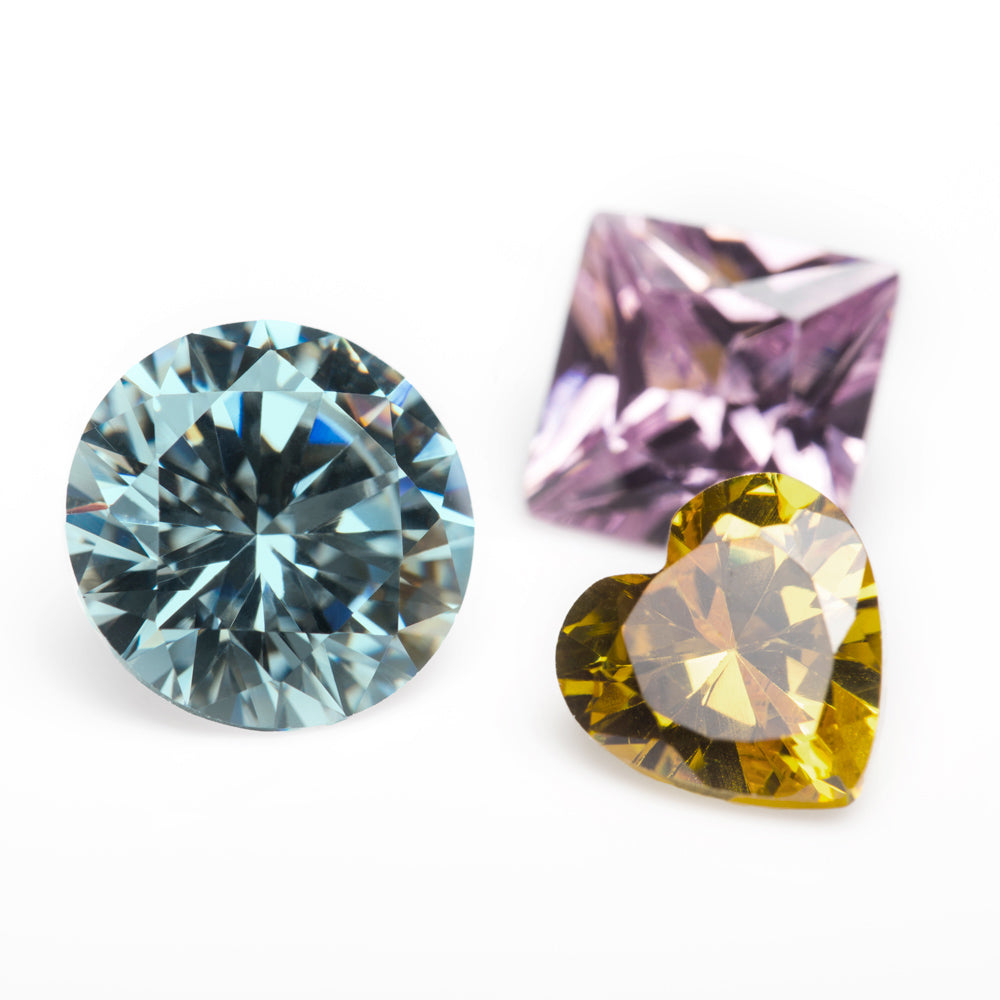 Colored lab-grown diamonds in pink, blue, and yellow. 